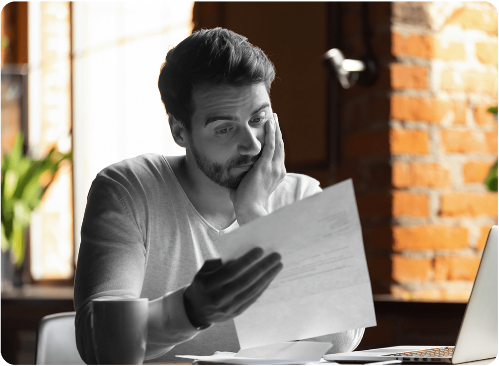 confused frustrated young man reading letter in cafe debt notification bad financial report